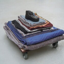 Mes Transports, 2012-13, Various objects, wood, metal, wheels, blankets, black wrap, 39 x 67 x 54 cm