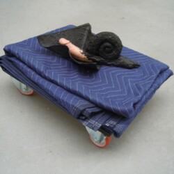 Mes Transports, 2012-13, Various objects, wood, metal, wheels, blankets, black wrap, 32 x 57 x 54 cm